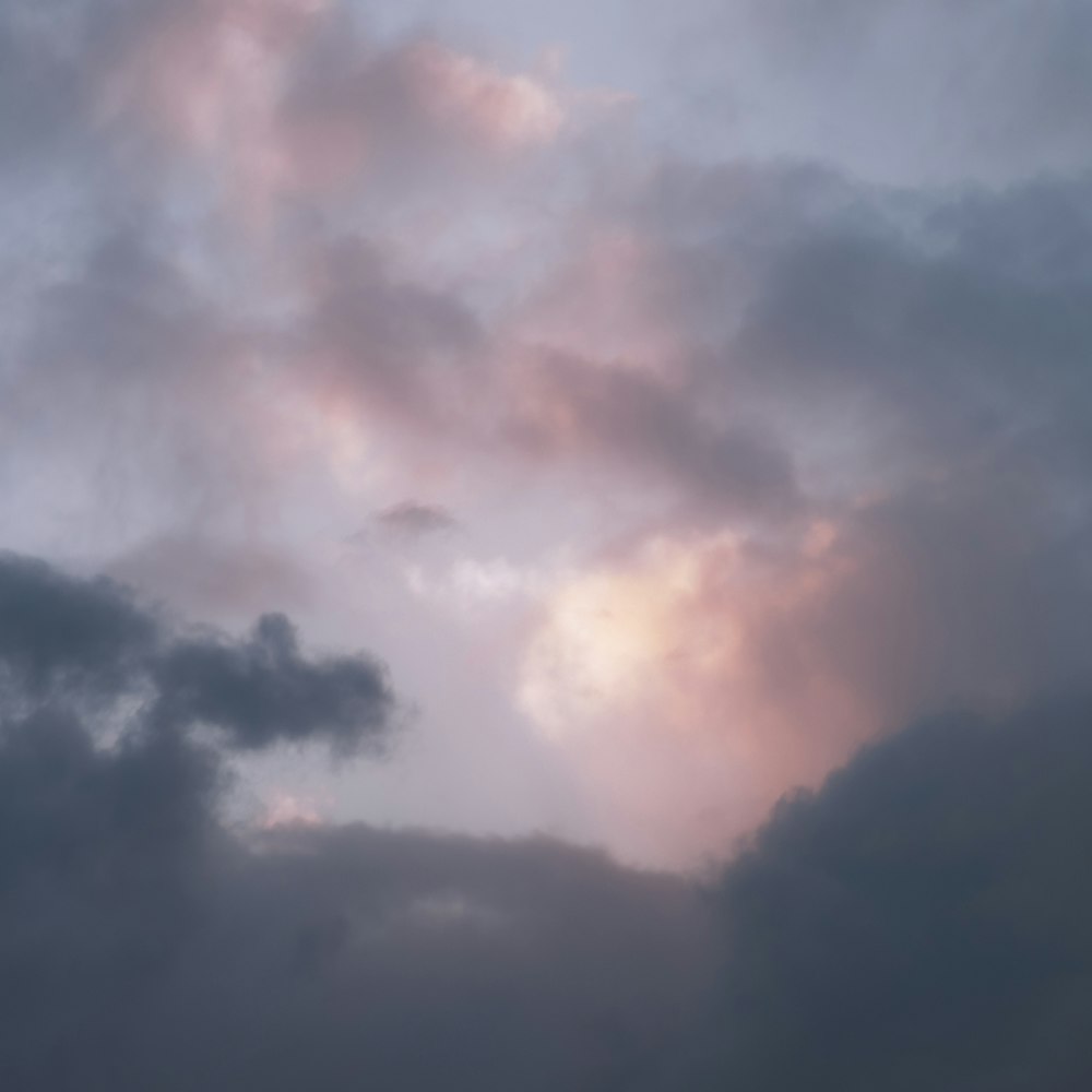 a plane flying in the sky with a lot of clouds