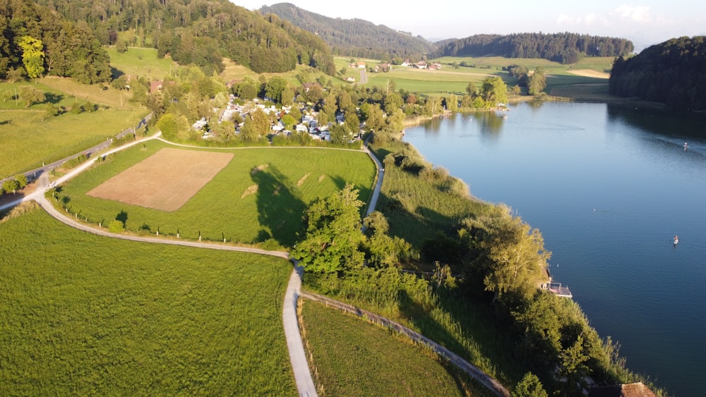 green grass field near lake during daytime