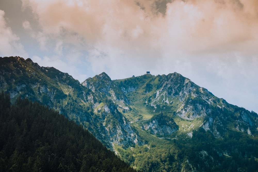 green and brown mountain under white clouds during daytime