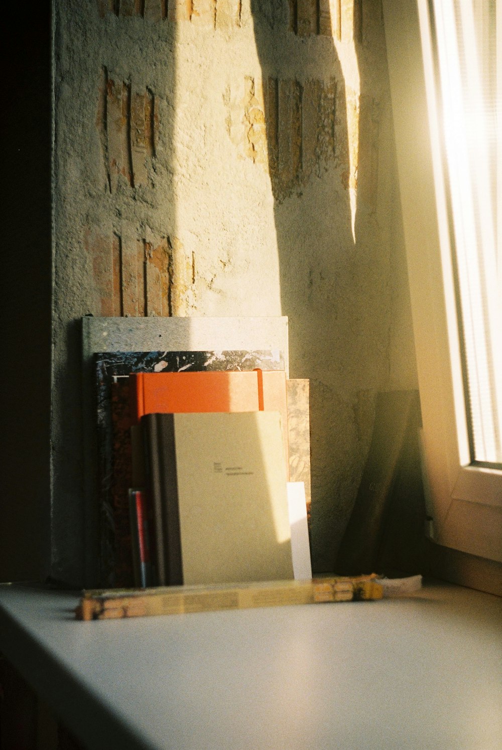 white and orange box on black wooden shelf