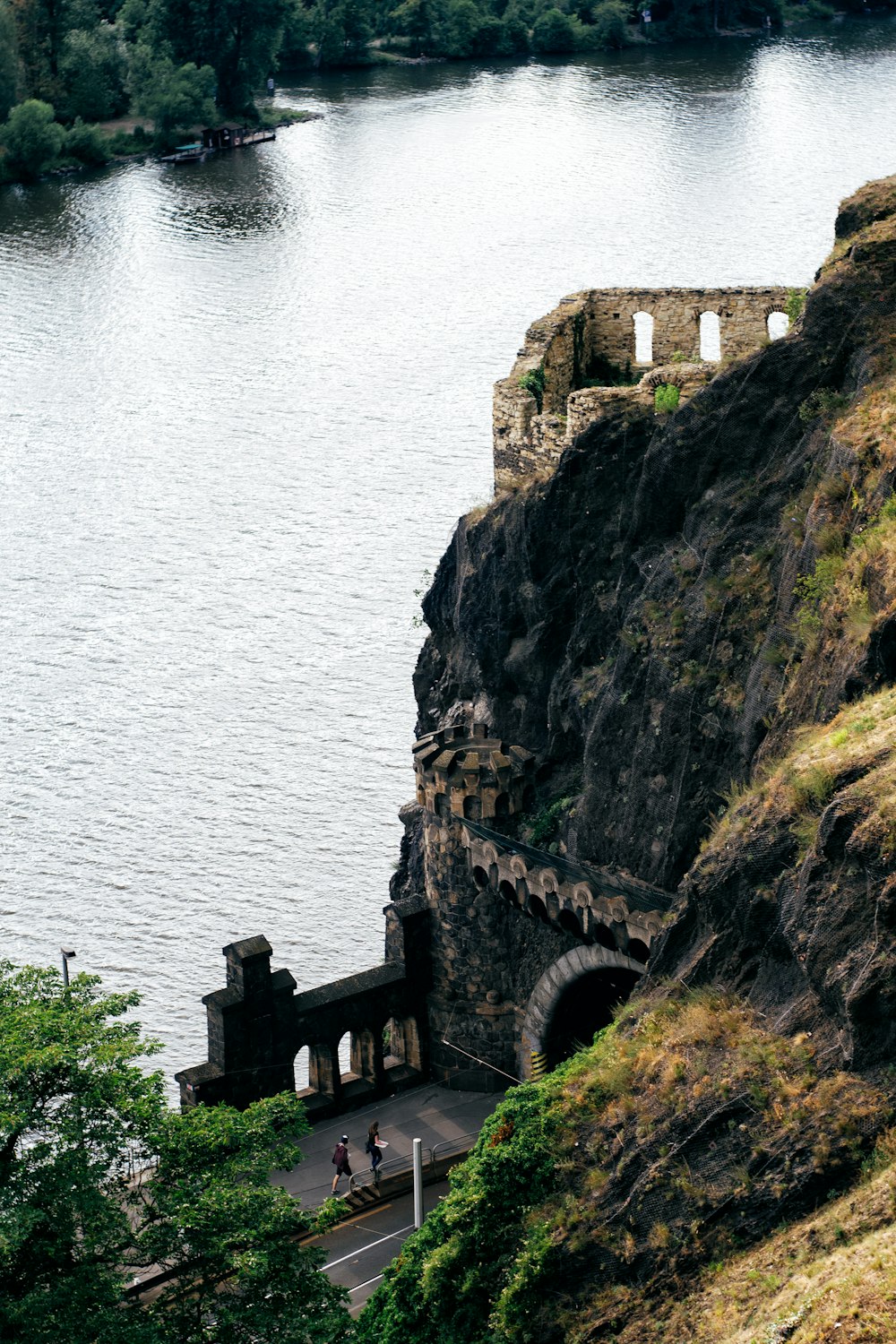 brown concrete building on cliff by the sea