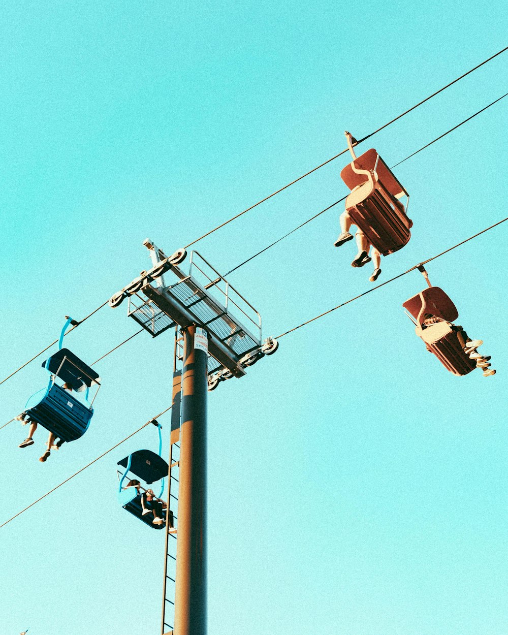black and brown cable cars under blue sky during daytime