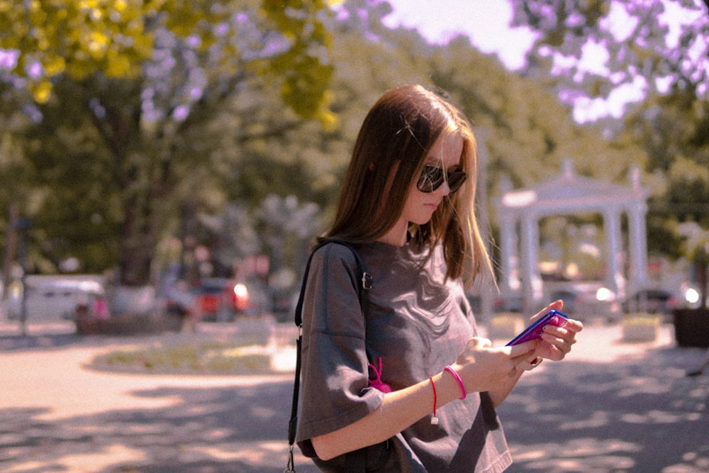 woman in black leather jacket holding smartphone