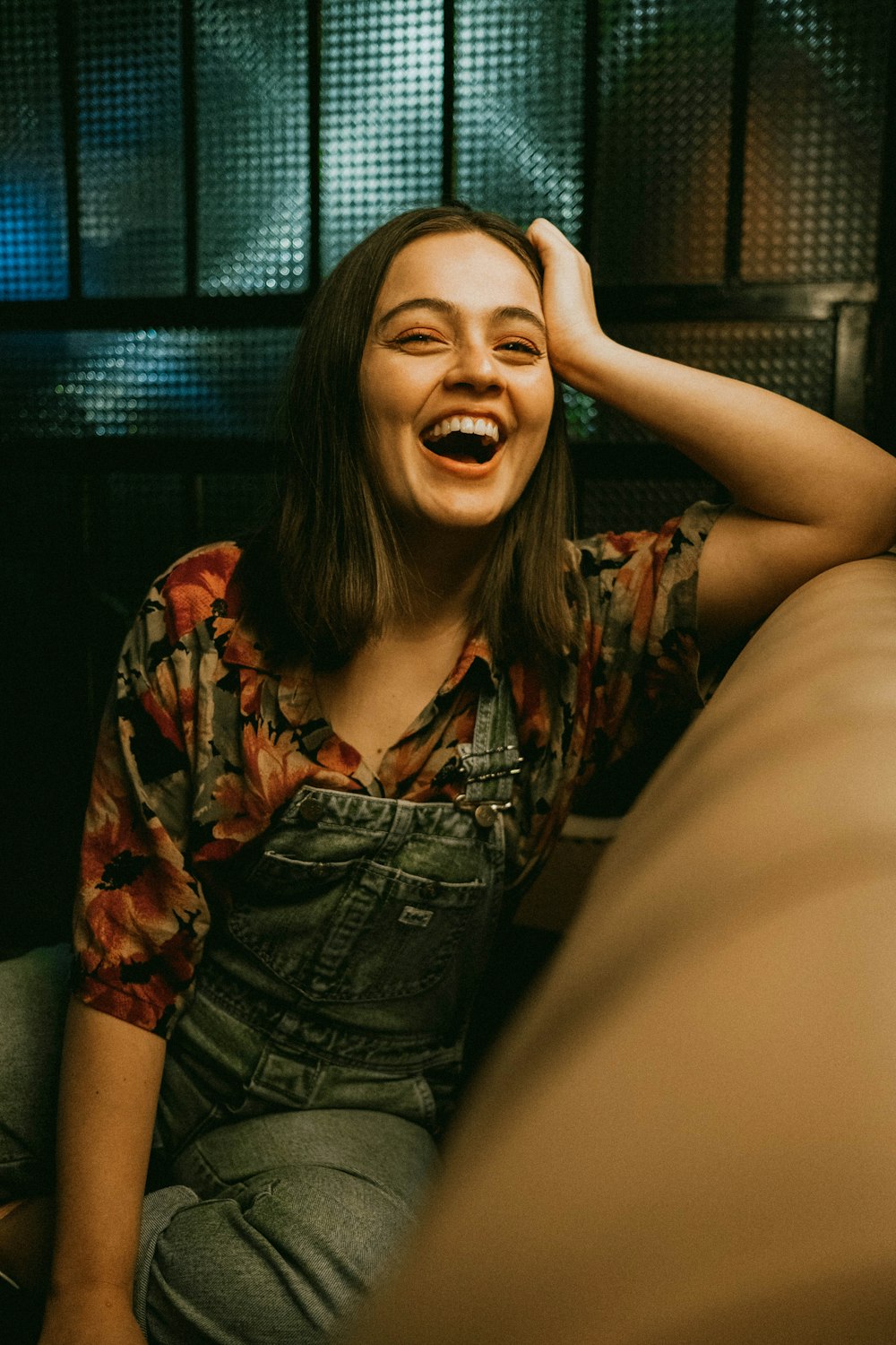 woman in brown and black button up shirt smiling