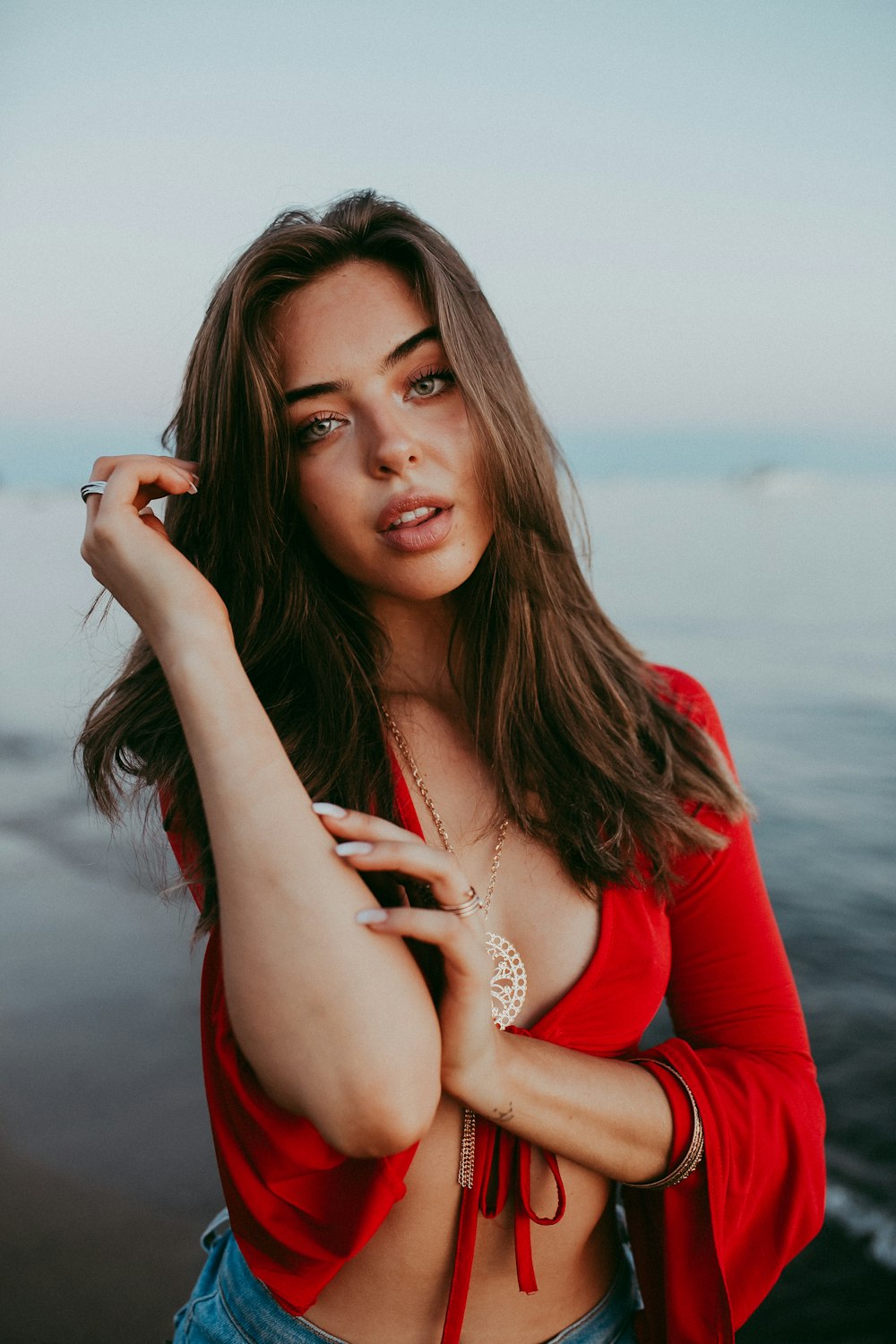 woman in red long sleeve shirt wearing silver bracelet