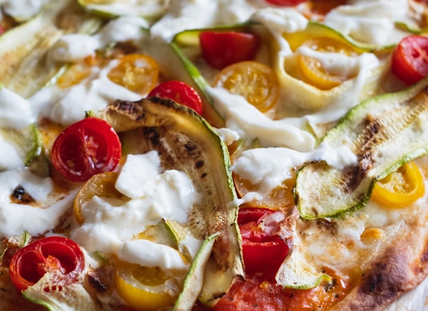 pizza with cheese and green leaves