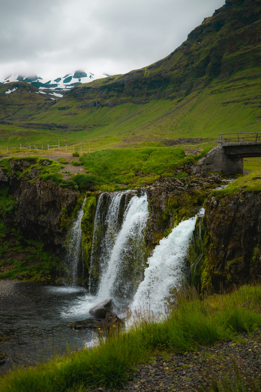 waterfalls on green grass covered hill during daytime