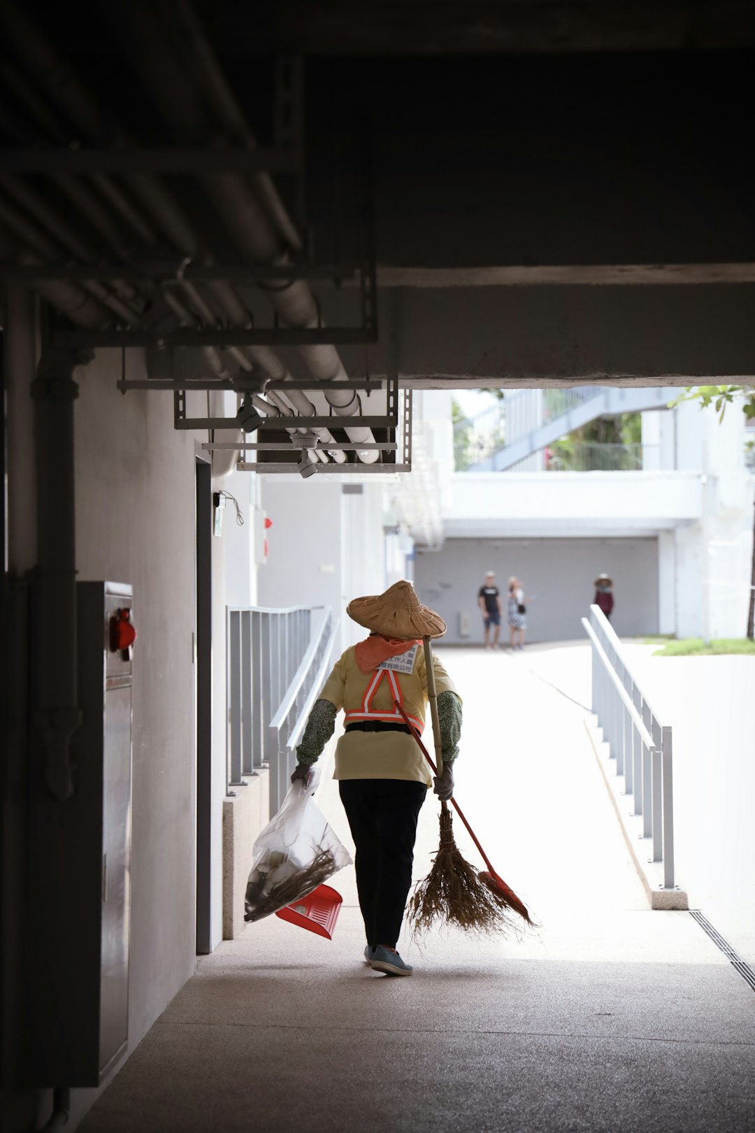 woman in white and red dress wearing brown hat standing on white concrete building during daytime