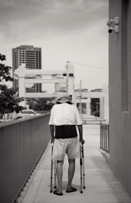 Photo of a person walking with supportive braces to manage CMT symptoms.