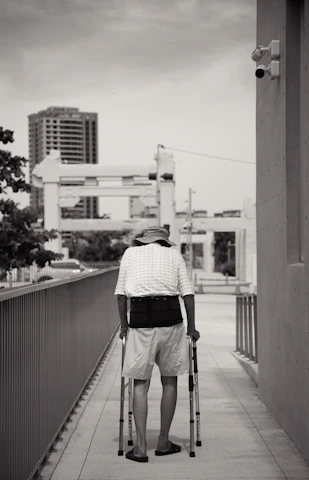 Photo of a person walking with supportive braces to manage CMT symptoms.