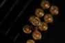 gold round coins on black surface