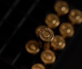 gold round coins on black surface