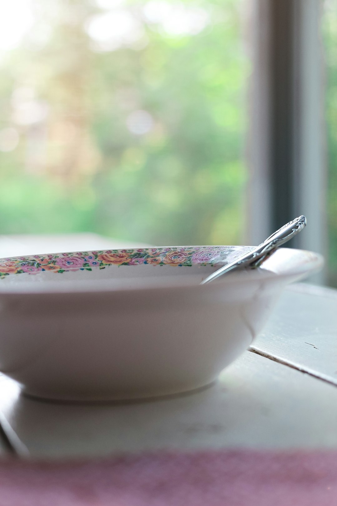 silver spoon on white ceramic bowl