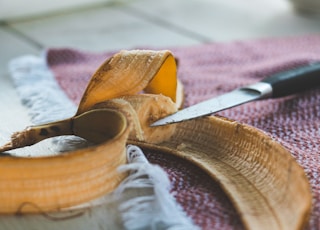 sliced yellow fruit on brown wooden chopping board