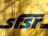 Faded yellow wooden boards serve as a backdrop for a large, bold and stylized blue and red logo that reads 'sfsr.' The wood appears weathered with some chips and visible nail marks, while shadows add texture and depth.