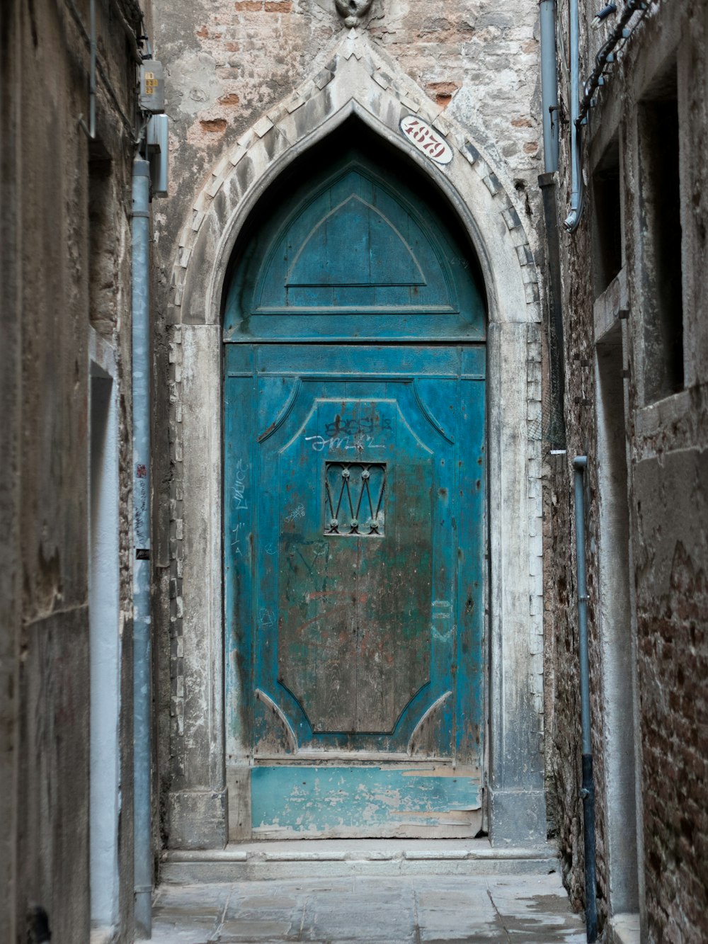 brown wooden door on gray concrete building