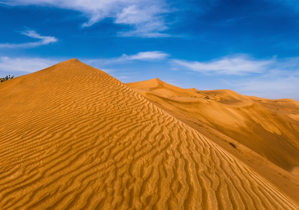 brown sand under blue sky during daytime