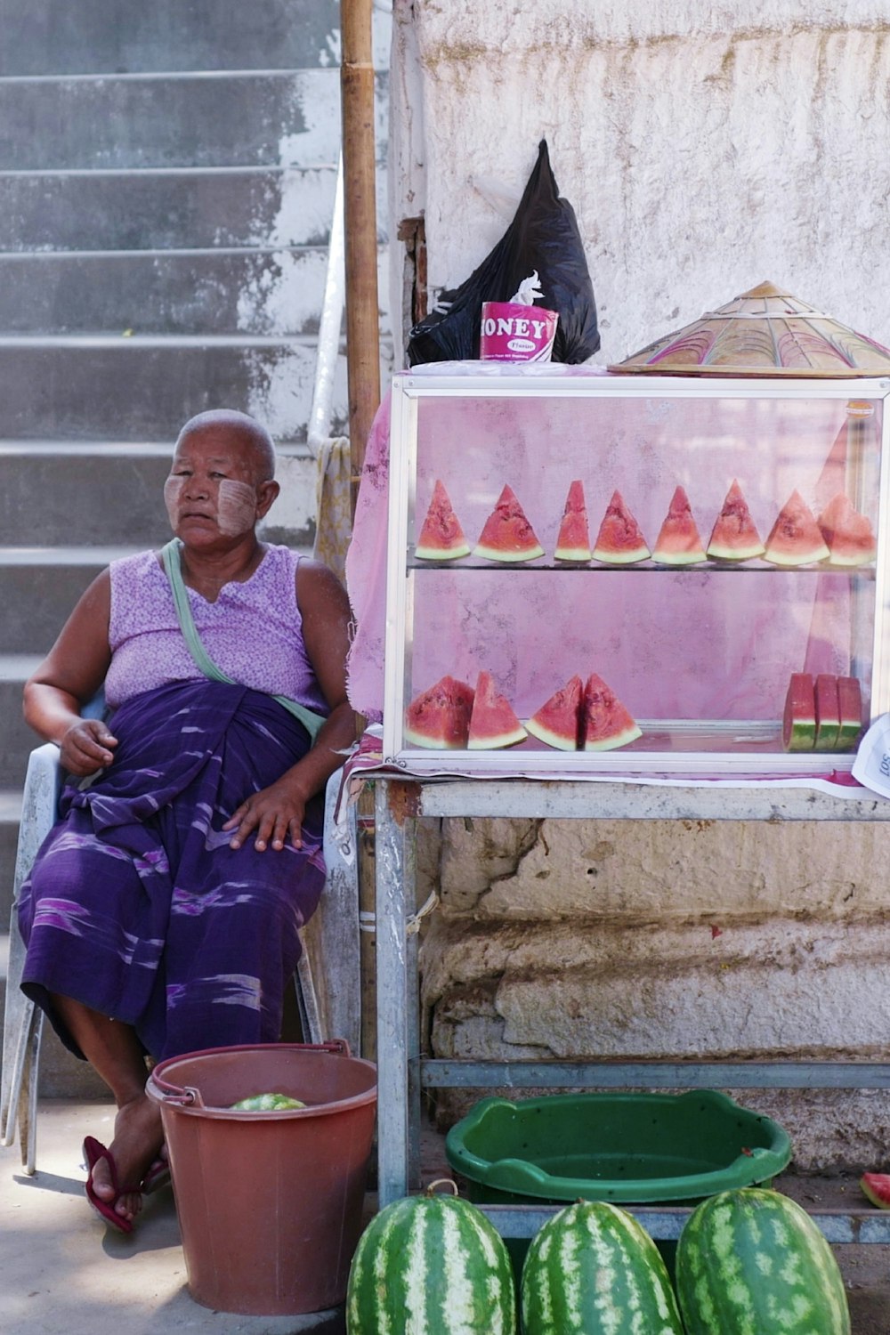 woman in purple tank top sitting on stairs