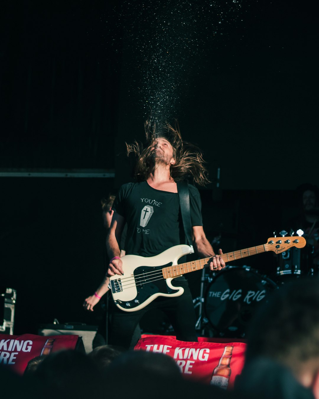 man in black crew neck t-shirt playing electric guitar