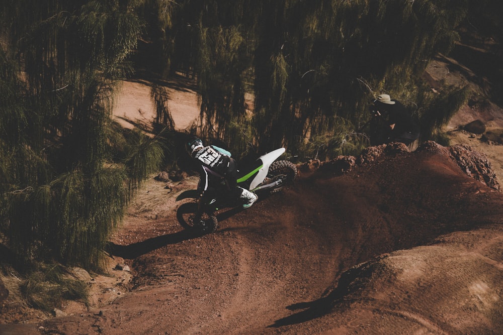 a person riding a dirt bike on a dirt track