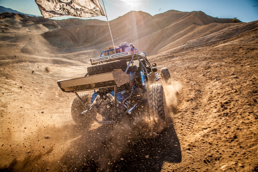 black and blue atv on brown sand