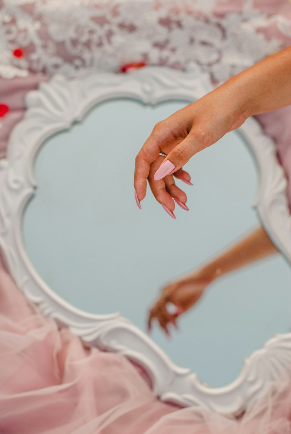 persons hand on white textile