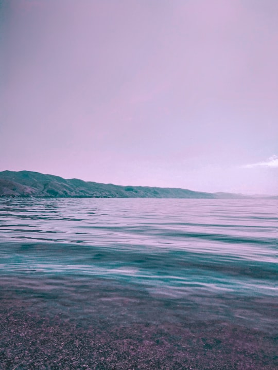 body of water near mountain during daytime in Sevan Armenia