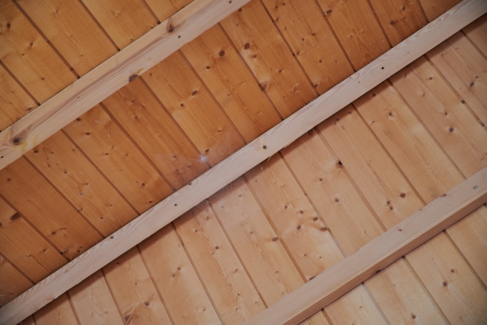 brown wooden ceiling with white fluorescent lamp