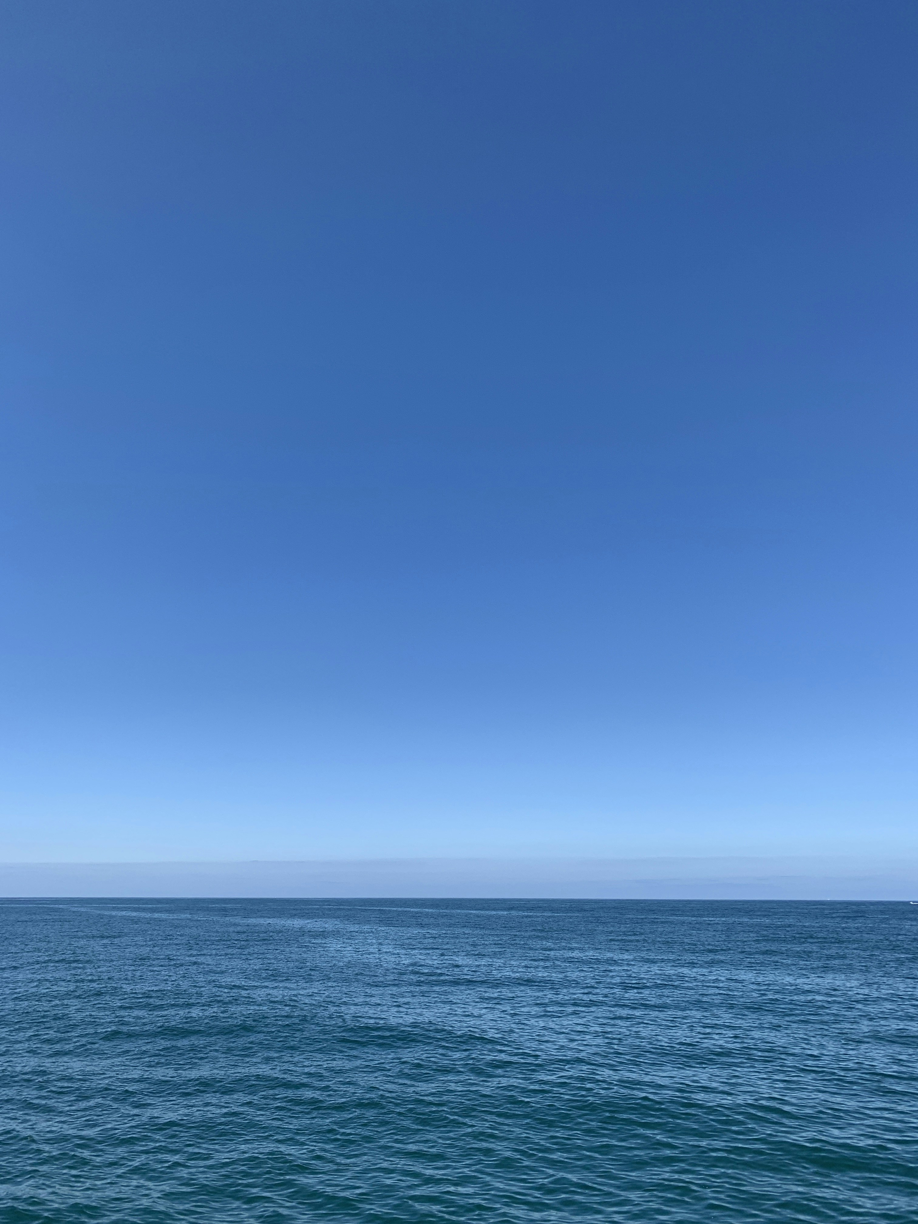 Blue Ocean Under Blue Sky During Daytime Photo Free Image On Unsplash