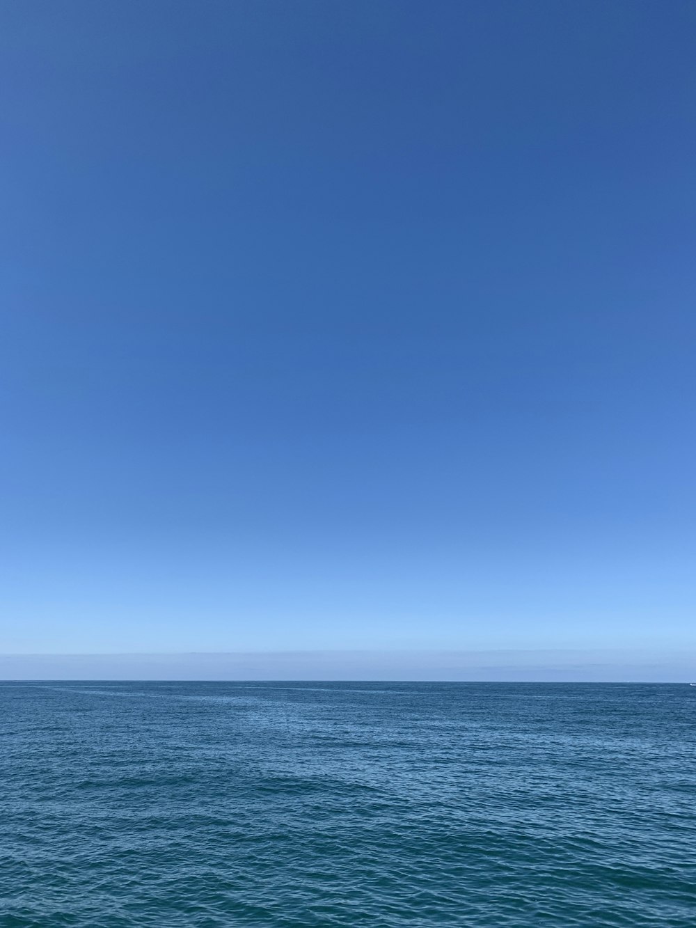 blue ocean under blue sky during daytime