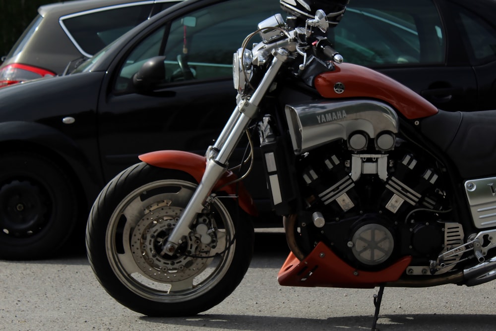 black and red motorcycle on road during daytime