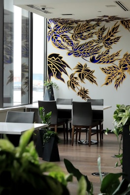 A stylish dining area with a large wallpaper art mural creating a bold visual statement.