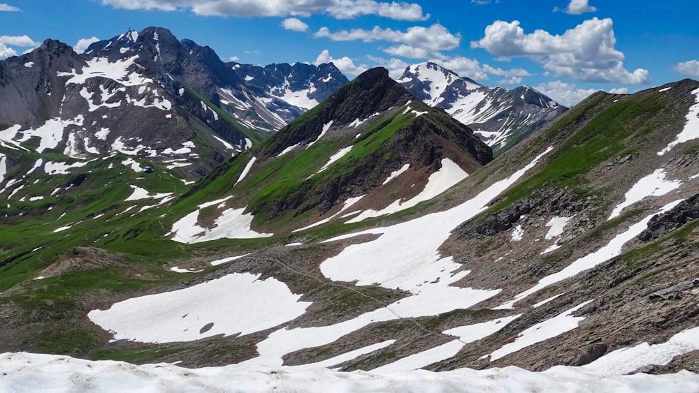 green and white mountains under white sky during daytime