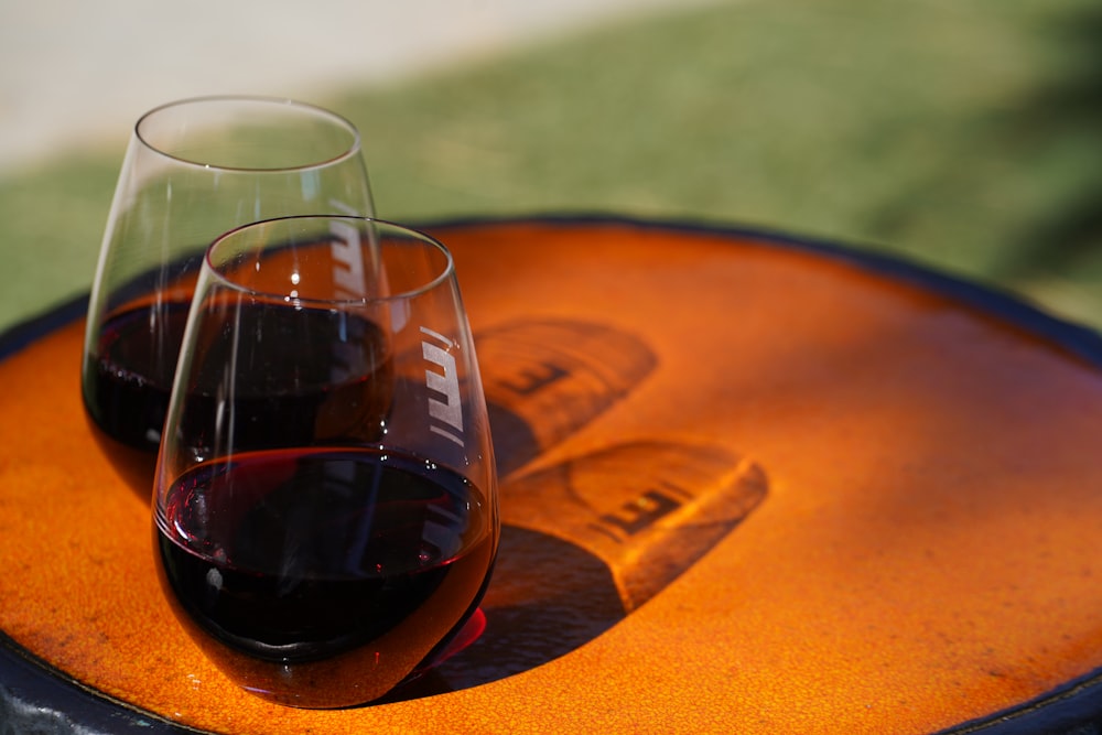 clear drinking glass on brown wooden table