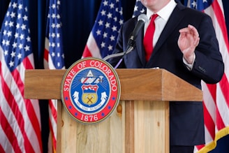 man in black suit jacket wearing black necktie