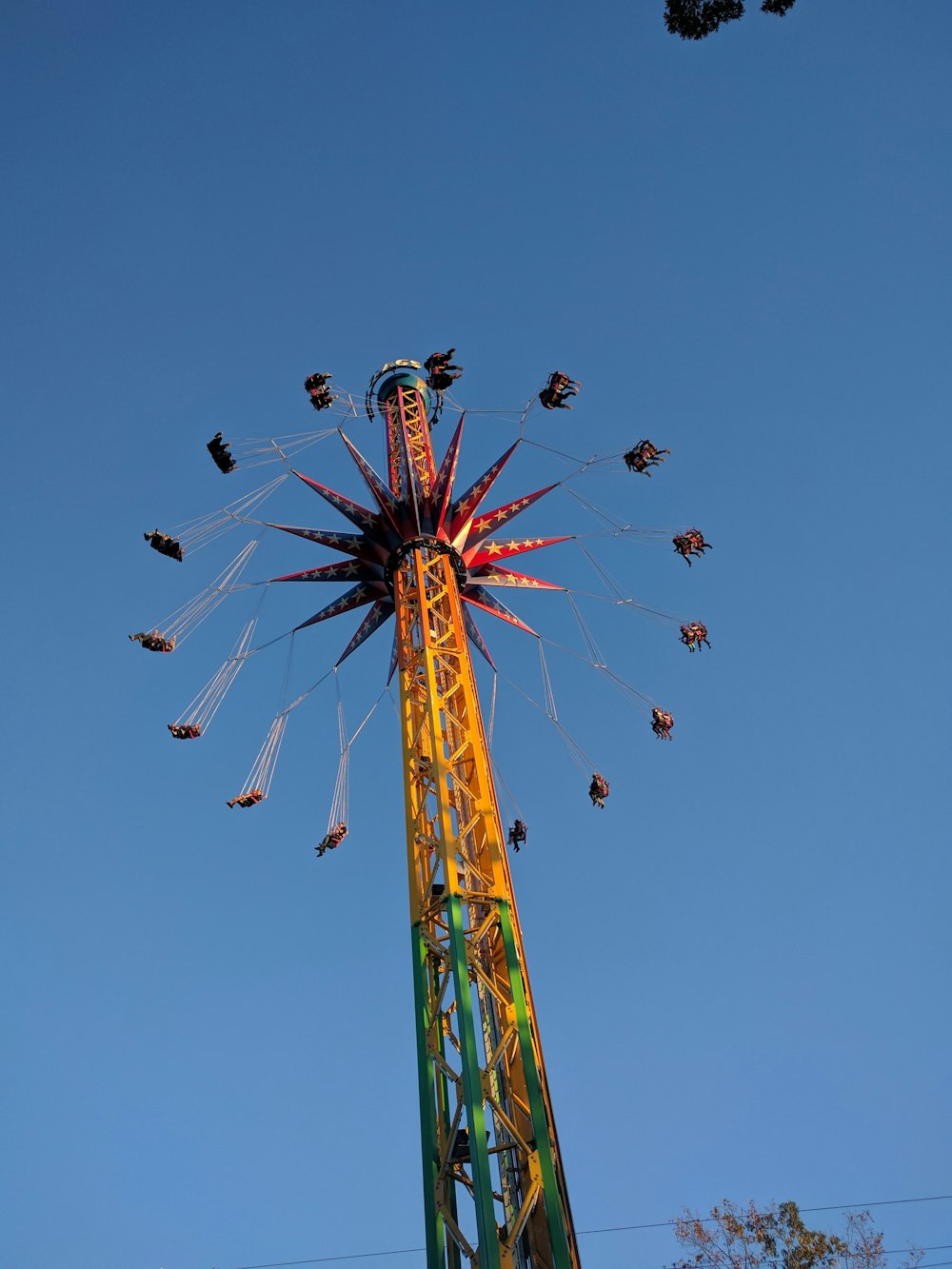 people riding on green and red roller coaster during daytime