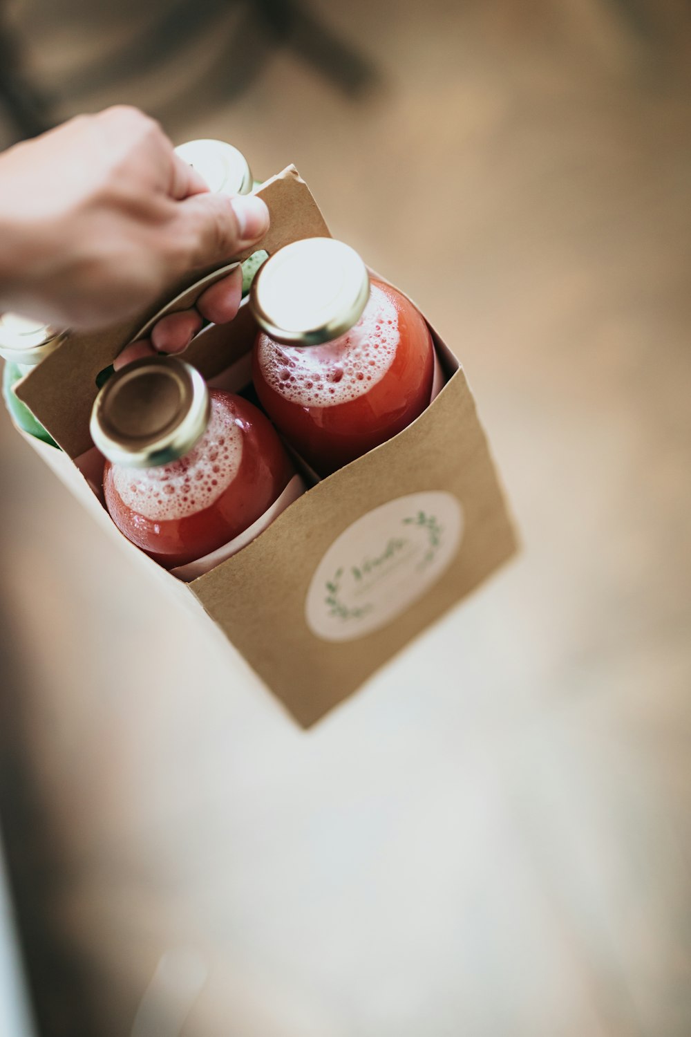 person holding red and brown gift box