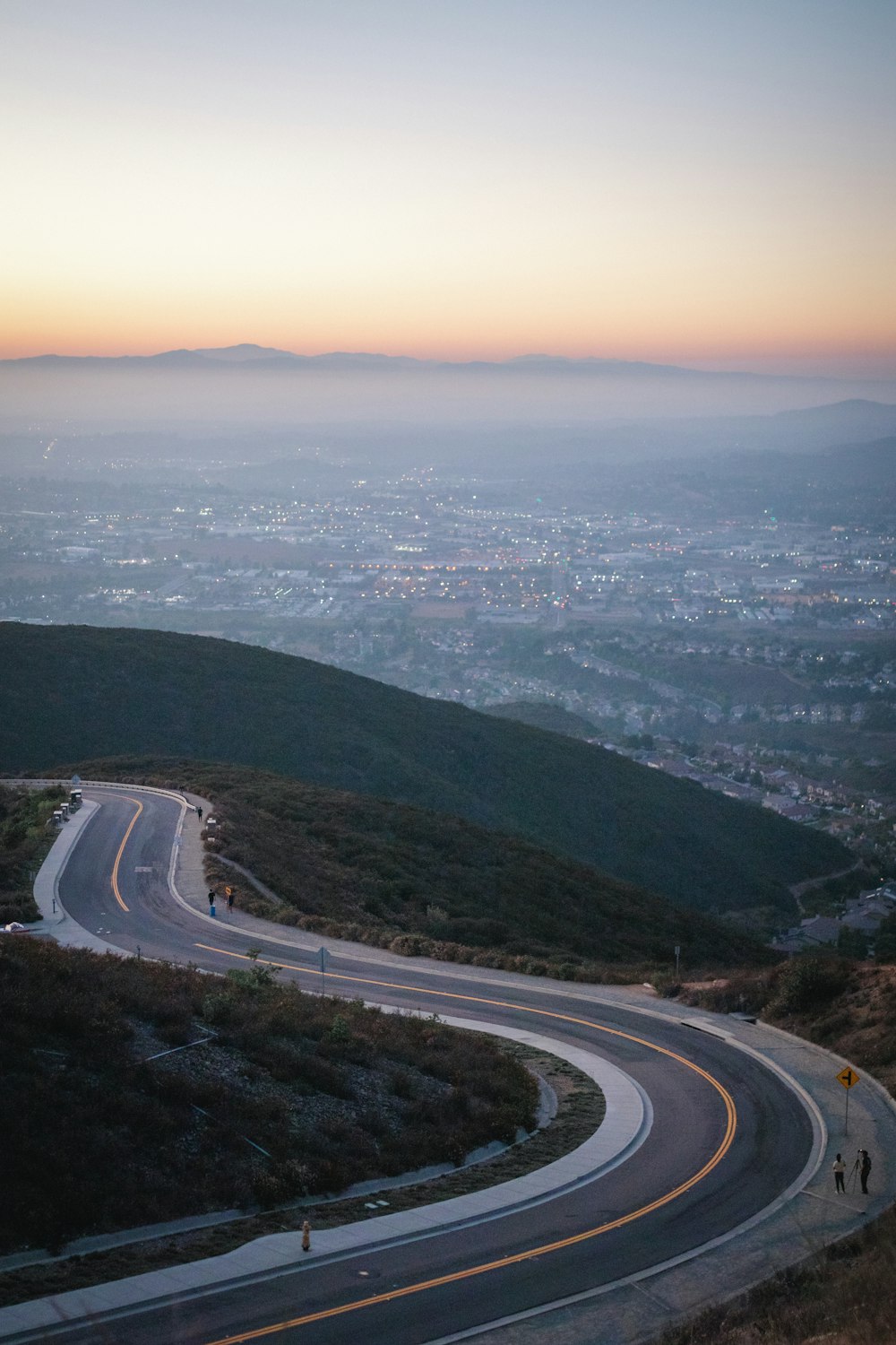 aerial view of road near body of water during daytime