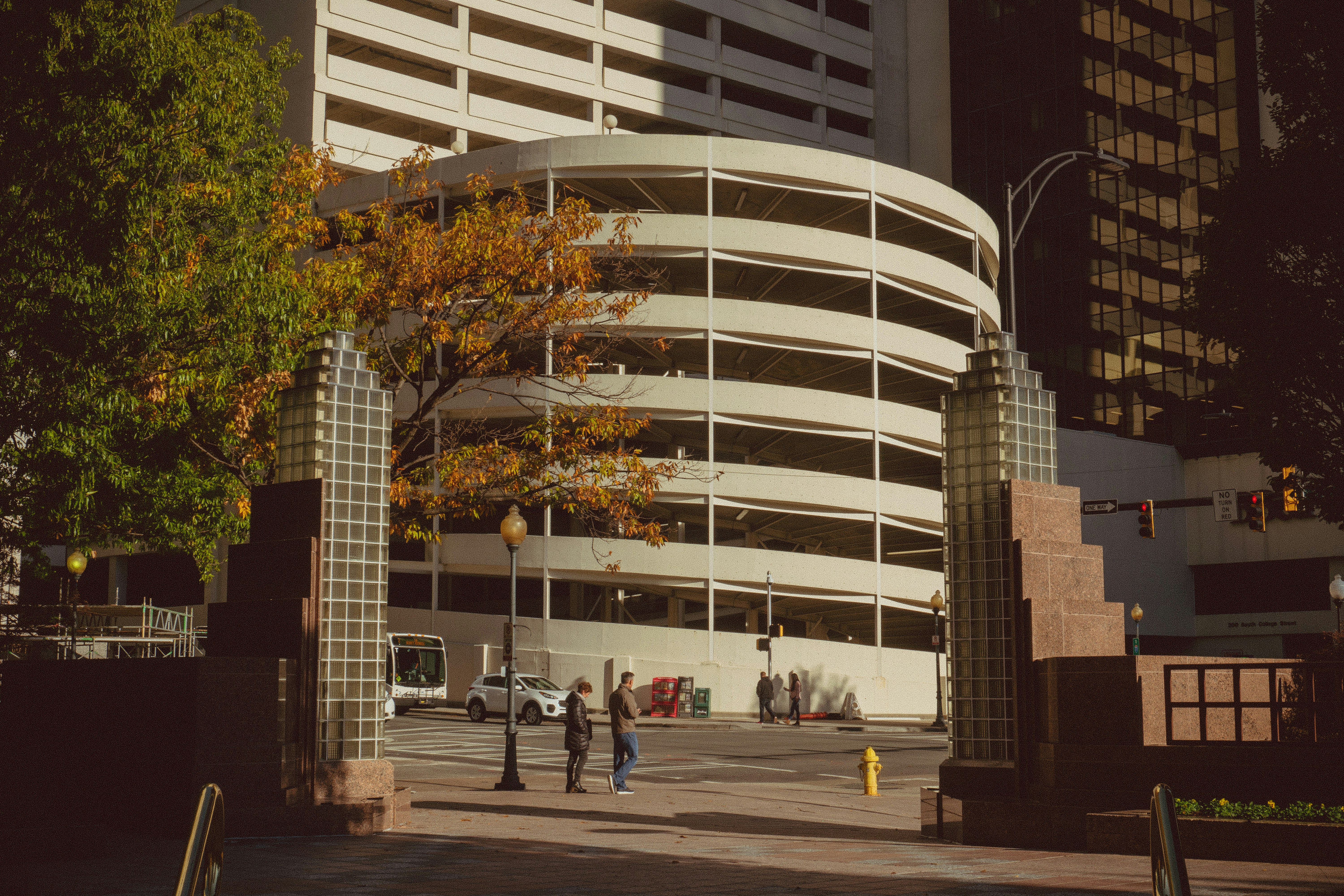 people walking on sidewalk near white concrete building during daytime