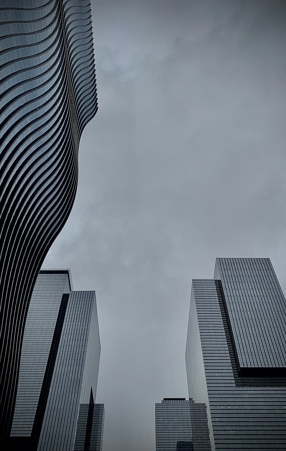 a couple of tall buildings sitting next to each other