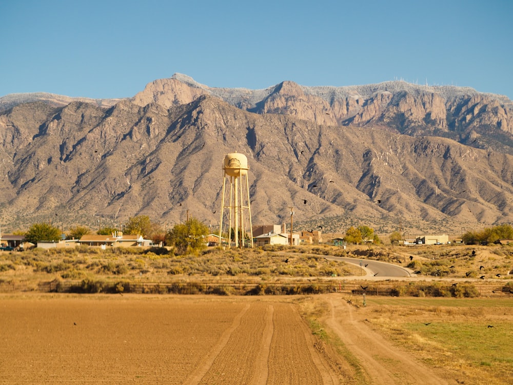 white tower near brown mountain during daytime