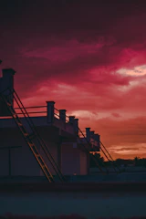 Golden dry ridge caps shining against a deep black tiled roof at sunset.