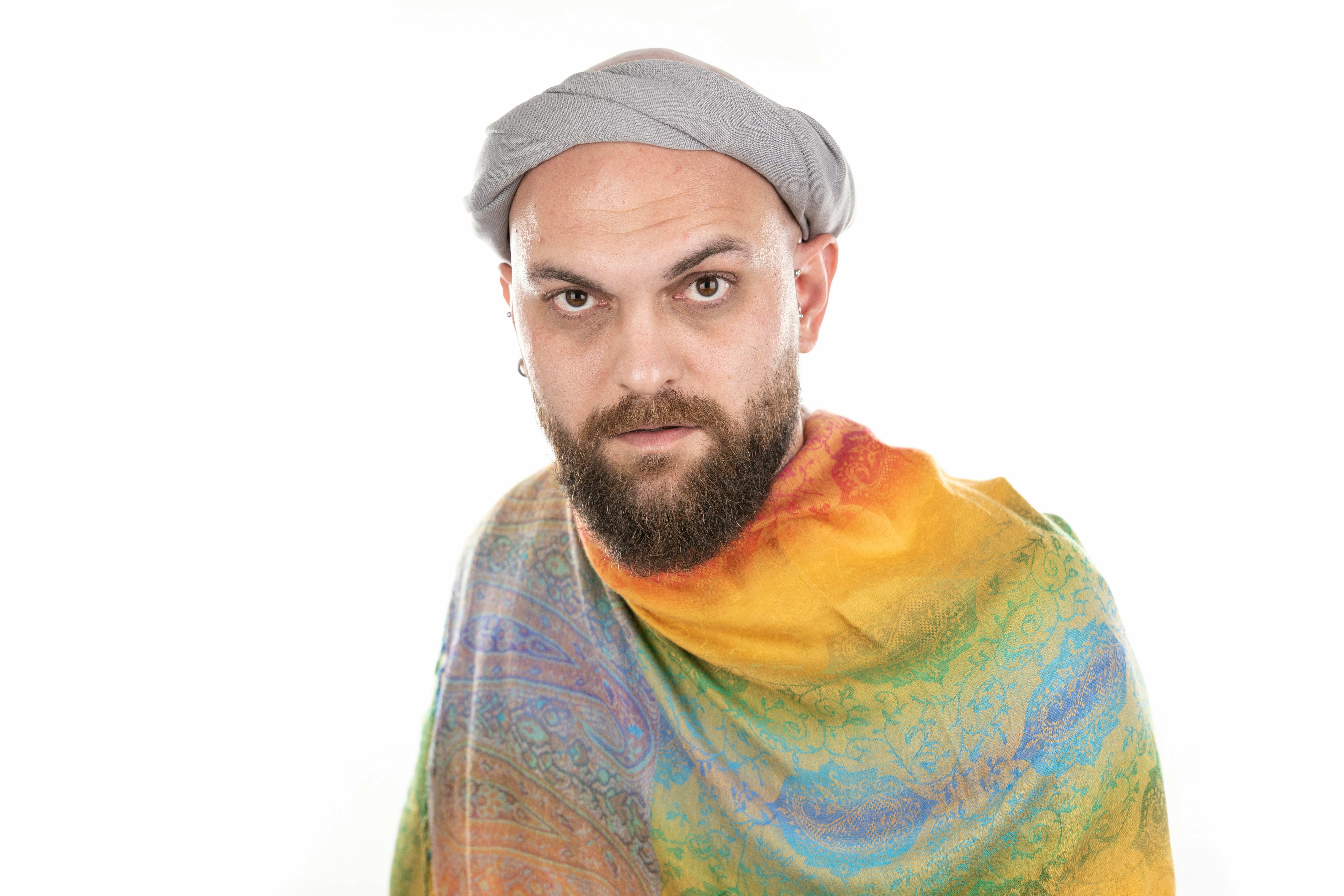 man in yellow green and blue scarf