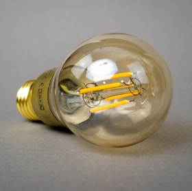 clear glass light bulb on white table