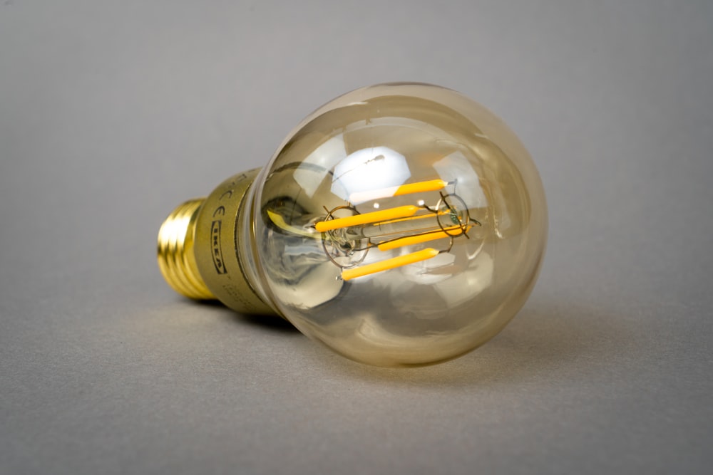 clear glass light bulb on white table