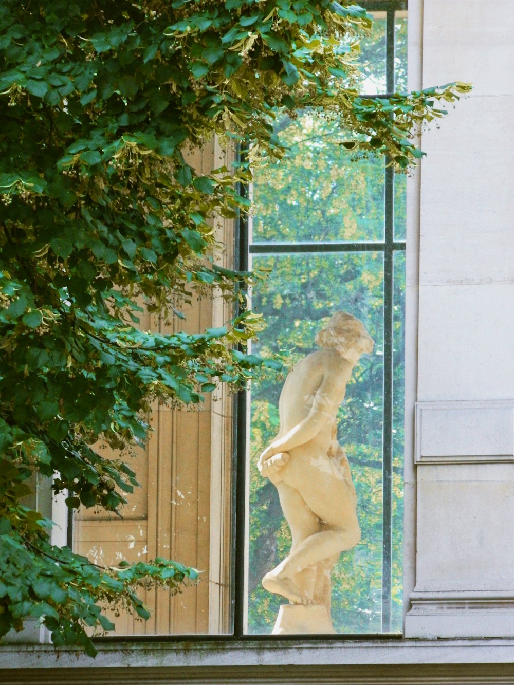 woman statue on white concrete wall