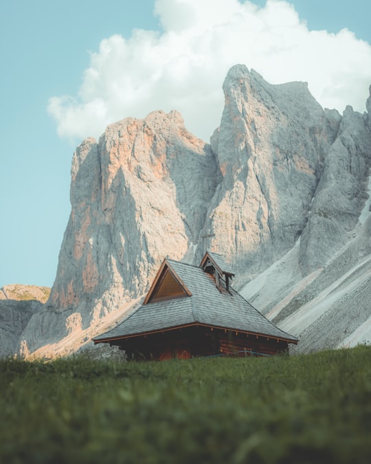 brown wooden house near gray rocky mountain during daytime in Funes Italy