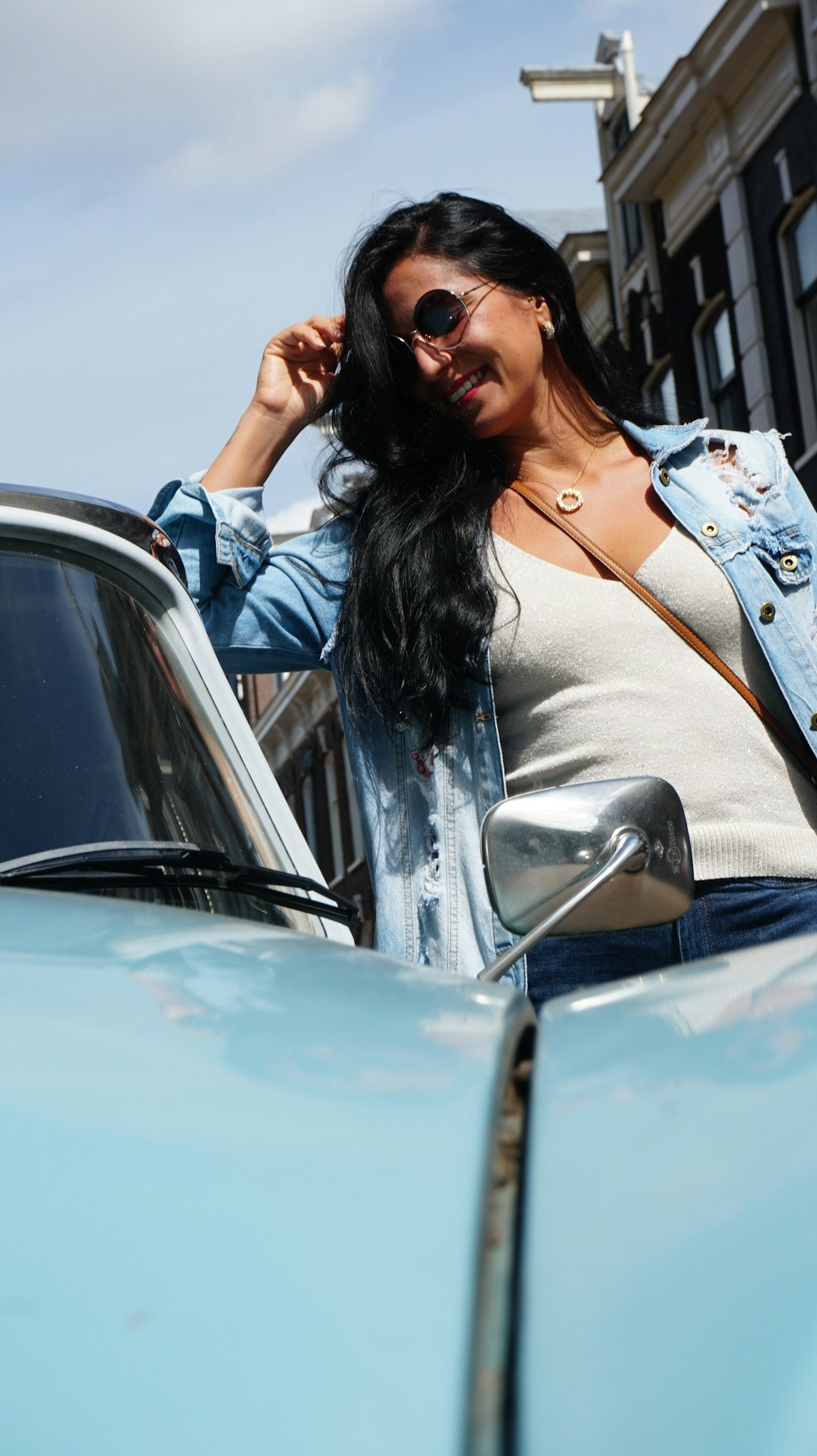 woman in white long sleeve shirt sitting on car