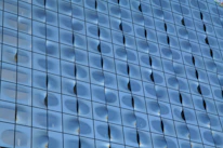 A detailed view of elegant glass panels being installed in a modern building facade.