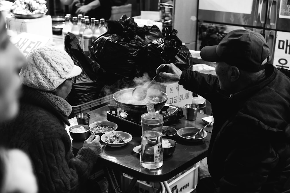 grayscale photo of man cooking